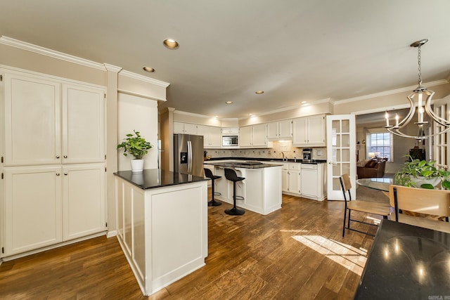 kitchen featuring stainless steel fridge with ice dispenser, white cabinetry, a center island, and pendant lighting