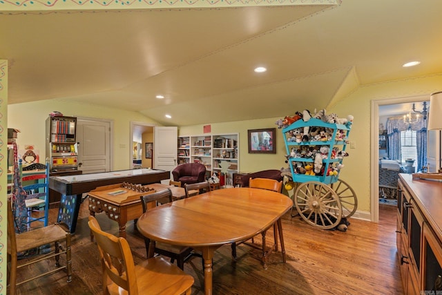 dining space with built in features, hardwood / wood-style floors, and lofted ceiling