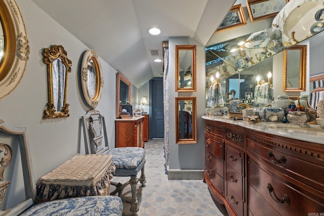 bathroom with vanity and vaulted ceiling