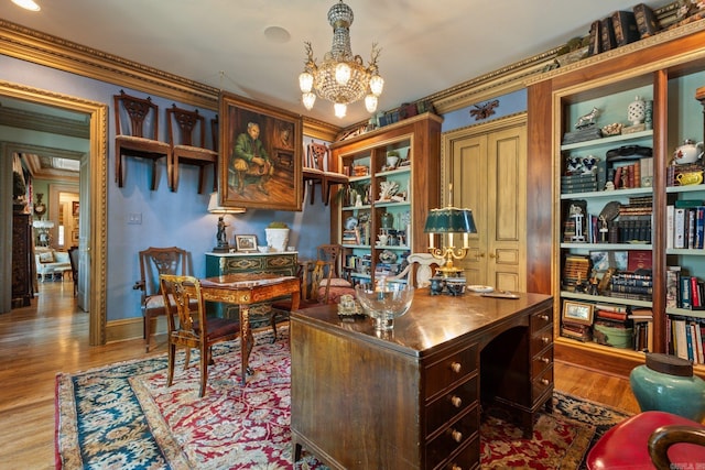 office space with a notable chandelier, crown molding, and light hardwood / wood-style flooring