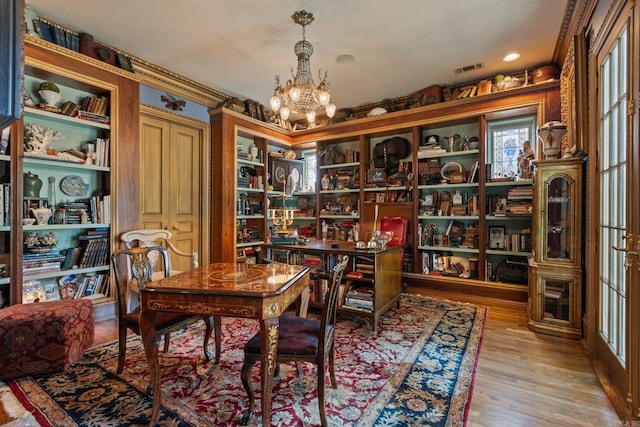 office space featuring light hardwood / wood-style floors and a chandelier