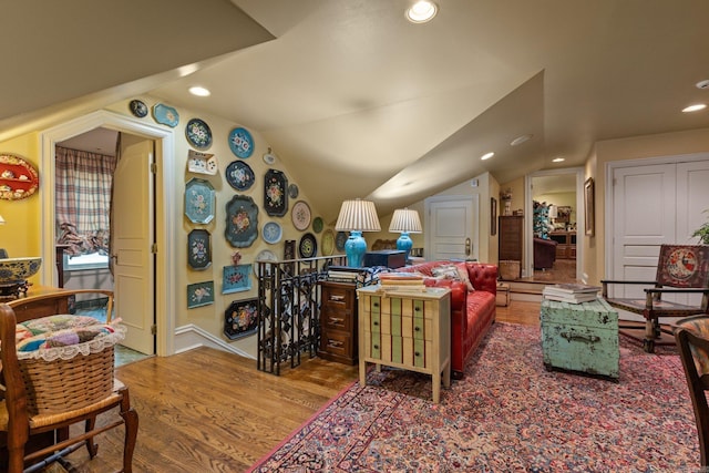 living room with wood-type flooring and vaulted ceiling