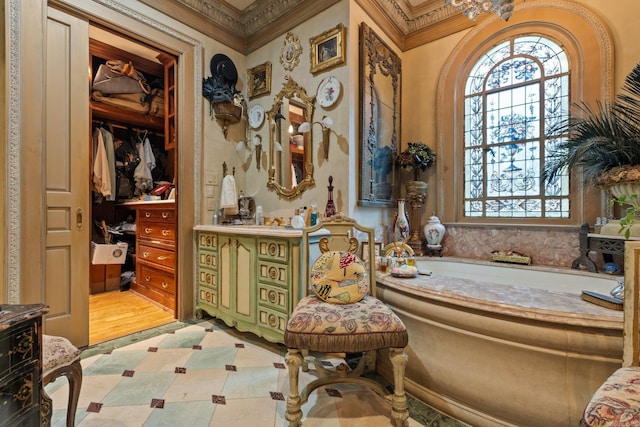 bathroom featuring tile patterned floors, a bathtub, crown molding, and vanity