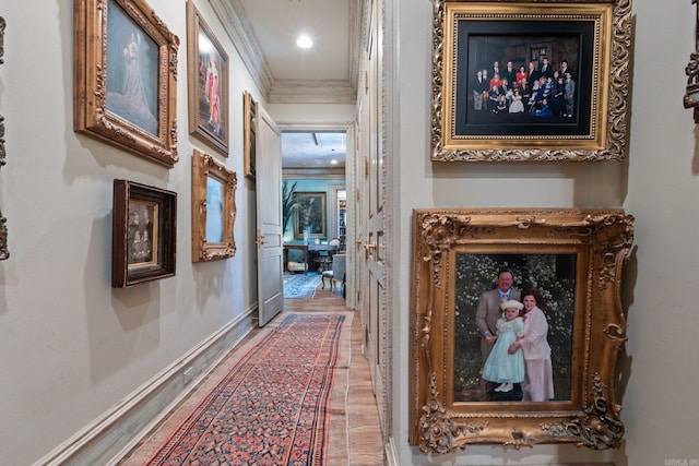 hall with hardwood / wood-style floors and crown molding