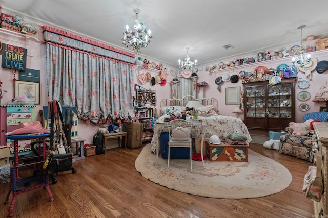 dining space with a chandelier, hardwood / wood-style floors, and ornamental molding