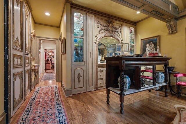 interior space with crown molding and light hardwood / wood-style flooring