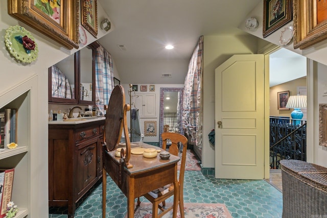 interior space with sink and vaulted ceiling