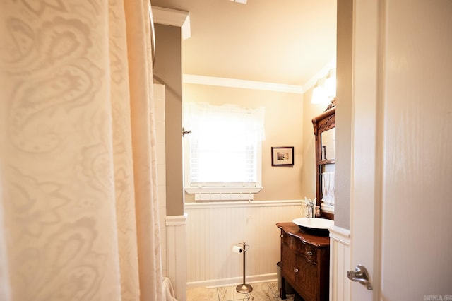 bathroom featuring crown molding and vanity