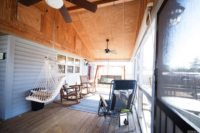 sunroom featuring ceiling fan and wooden ceiling