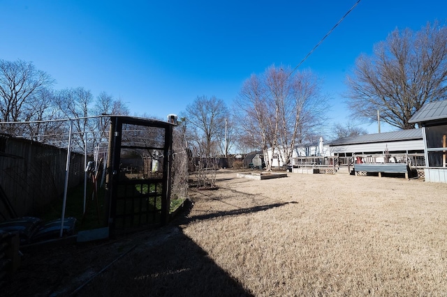 view of yard featuring a deck and an outdoor structure