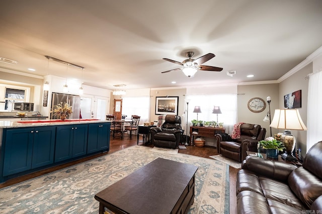 living room featuring ceiling fan, crown molding, and dark wood-type flooring