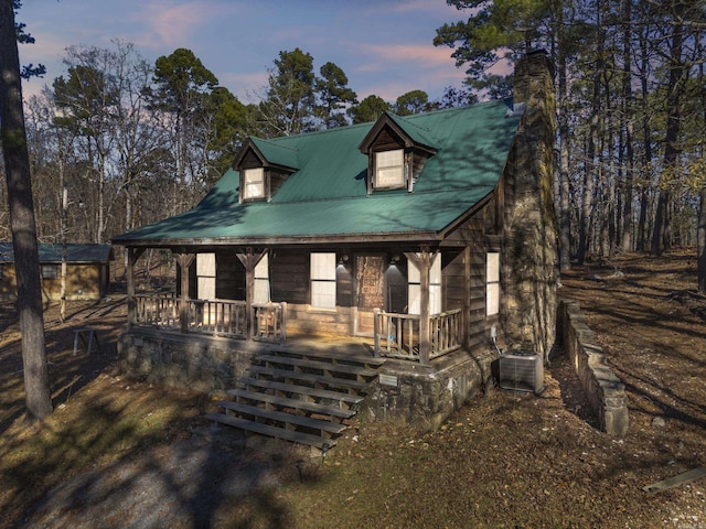 view of front of home featuring covered porch and central air condition unit