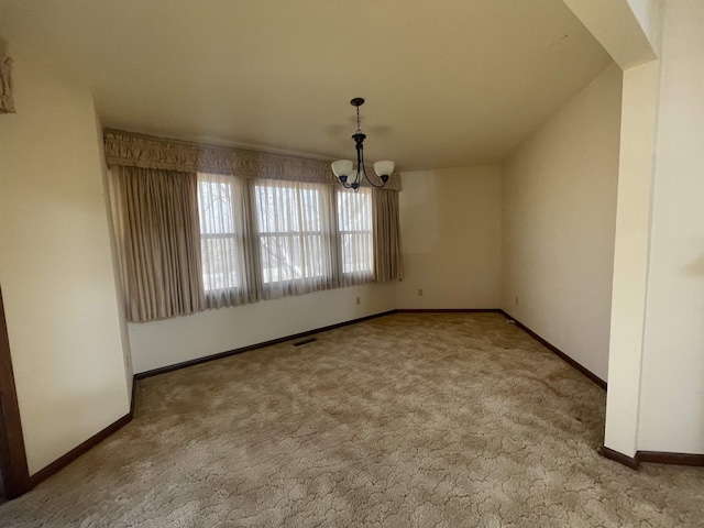 unfurnished dining area featuring a chandelier and light carpet