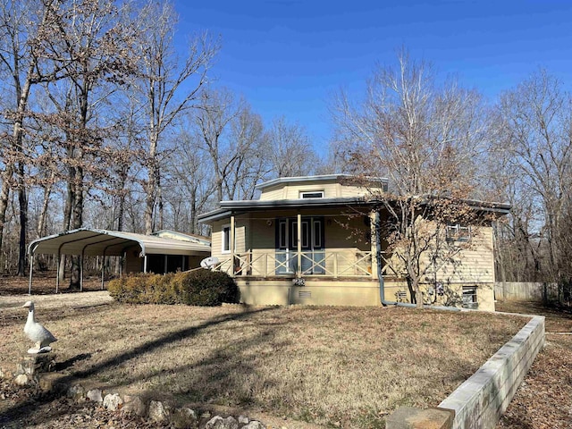 view of front of home with covered porch and a carport