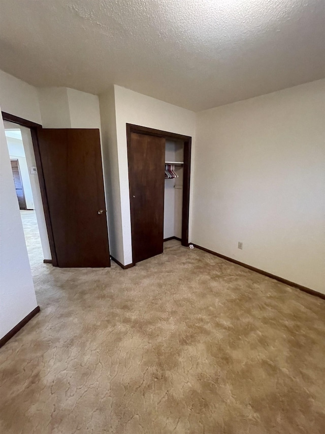 unfurnished bedroom with a textured ceiling and a closet