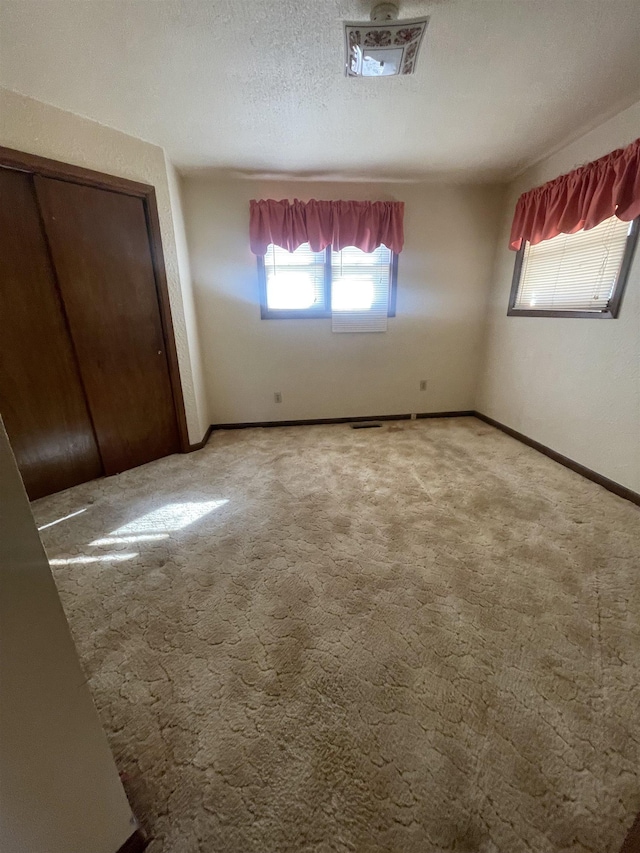 unfurnished bedroom featuring carpet and a closet