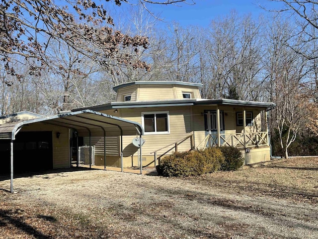 view of front of house featuring a porch and a carport