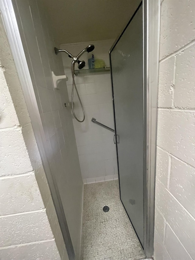 bathroom featuring a shower with door