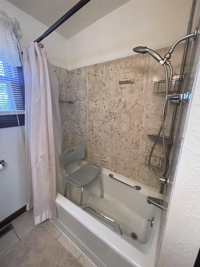 bathroom featuring shower / bath combo with shower curtain and tile patterned flooring