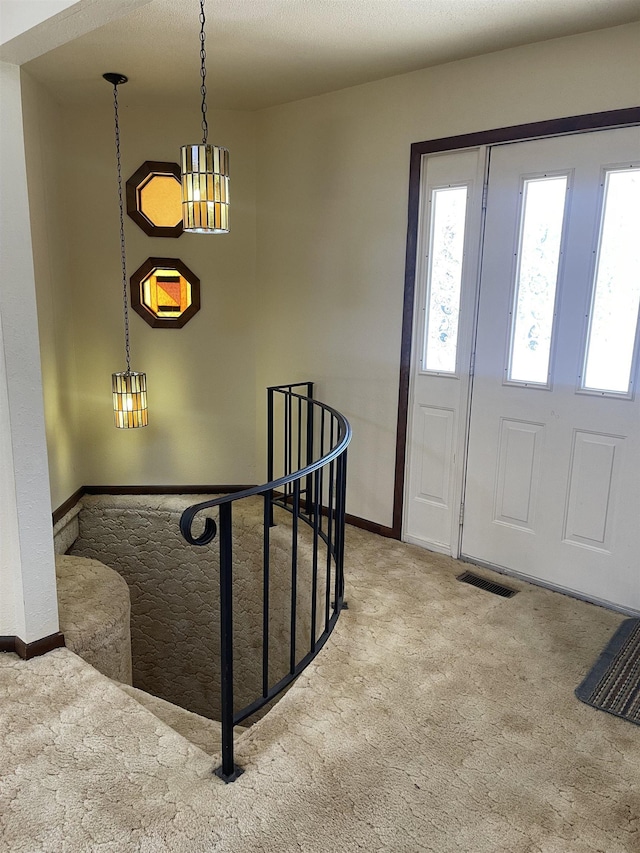 view of carpeted entrance foyer