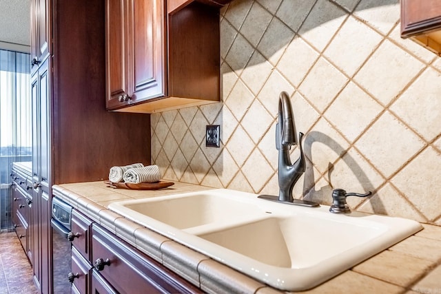 kitchen with tile counters and sink