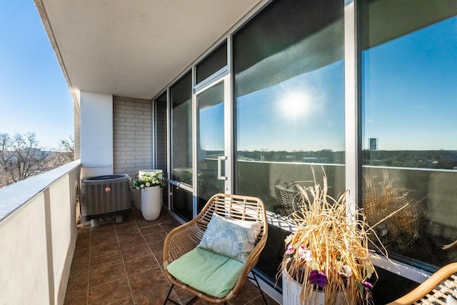 balcony featuring a water view and central AC