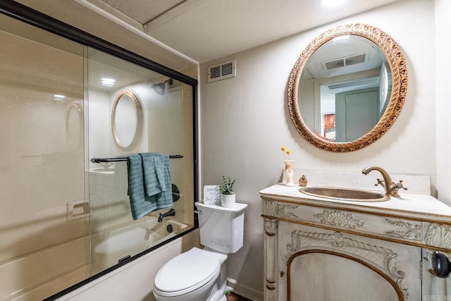 full bathroom with vanity, toilet, and shower / bath combination with glass door