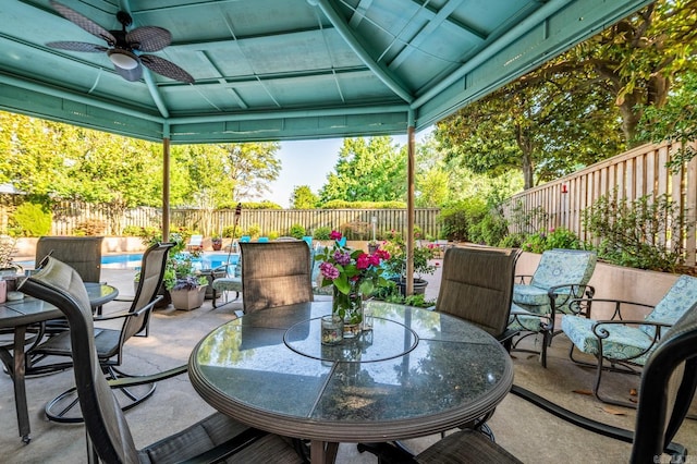 view of patio / terrace featuring a fenced in pool and ceiling fan