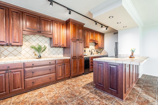 kitchen with tile counters, sink, a textured ceiling, decorative backsplash, and black appliances