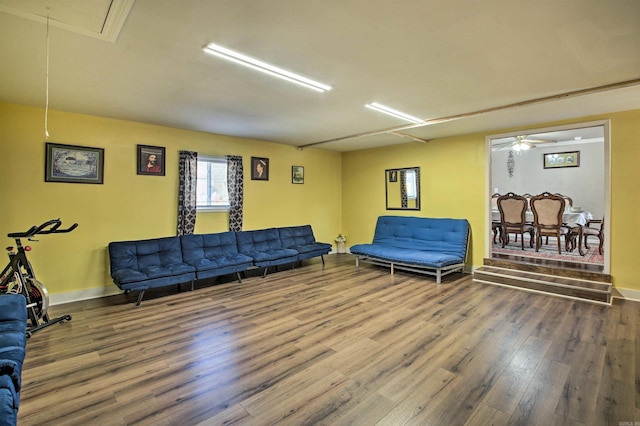 living room featuring hardwood / wood-style floors and ceiling fan