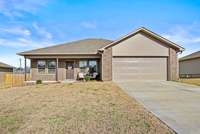 single story home with a front lawn, a porch, and a garage