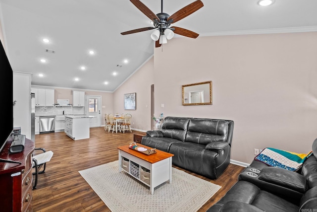 living room featuring dark wood-type flooring, vaulted ceiling, ceiling fan, and crown molding