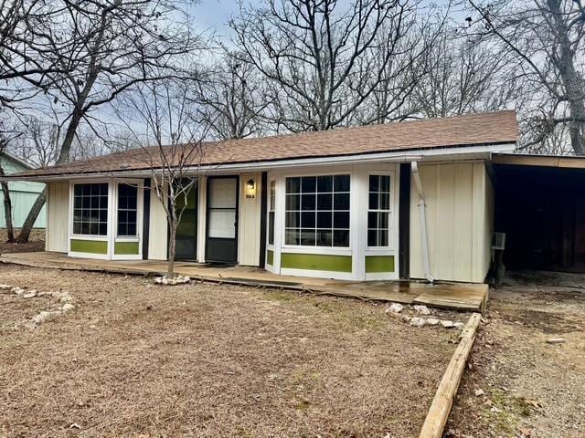 ranch-style house featuring a carport