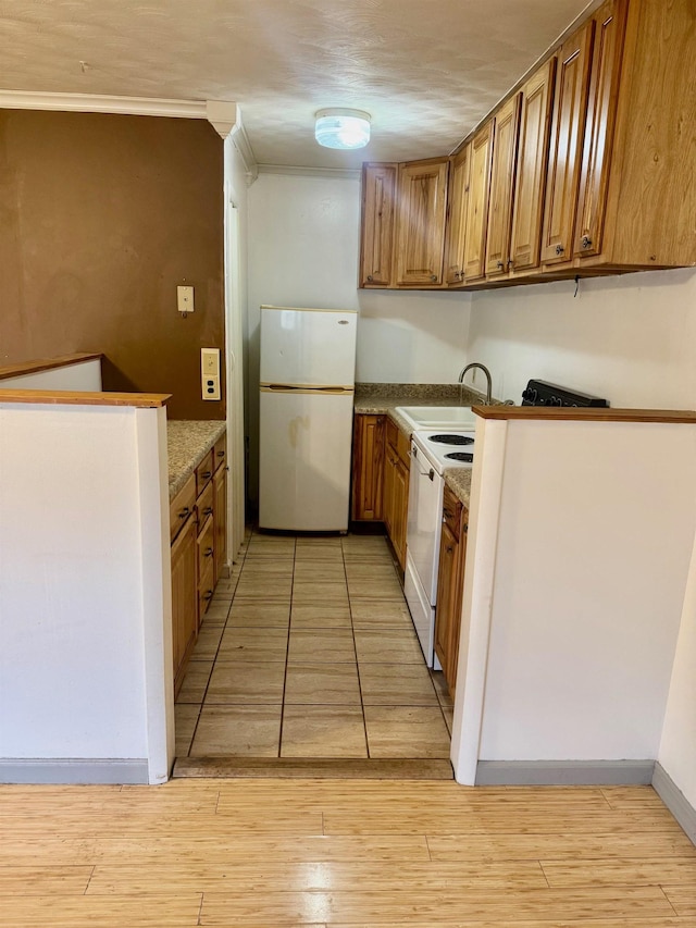 kitchen featuring dishwashing machine, white refrigerator, light hardwood / wood-style floors, and sink