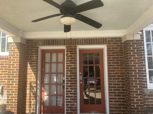 entrance to property with ceiling fan