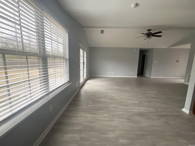 spare room with ceiling fan, dark hardwood / wood-style floors, and vaulted ceiling