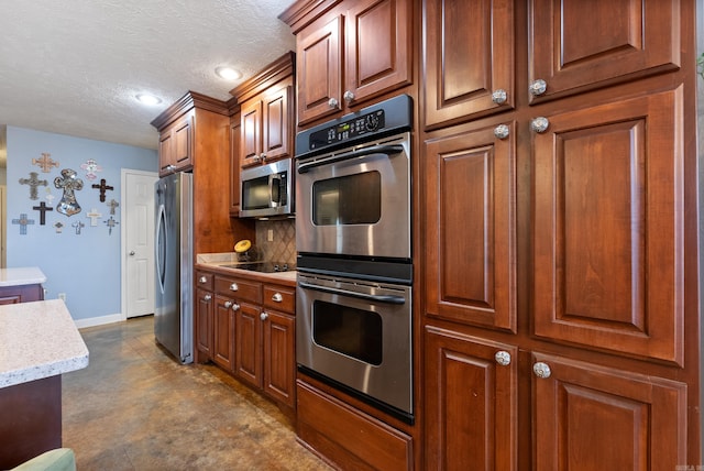 kitchen featuring a textured ceiling, stainless steel appliances, and backsplash