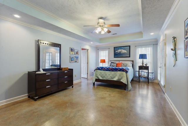 bedroom with a textured ceiling, a tray ceiling, ceiling fan, and ornamental molding