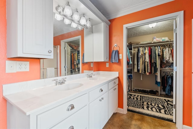 bathroom featuring vanity, ornamental molding, a textured ceiling, and concrete floors