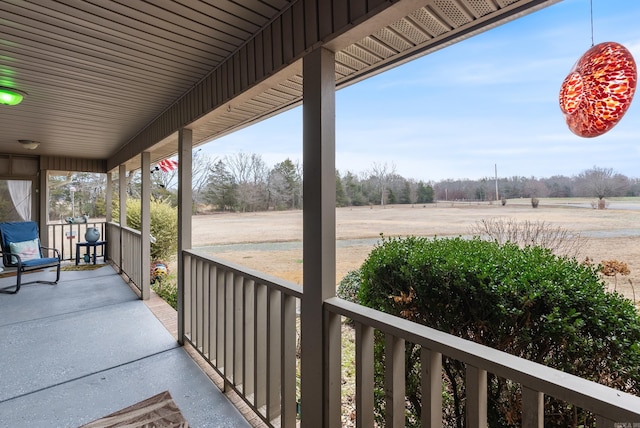 view of patio / terrace featuring covered porch and a rural view