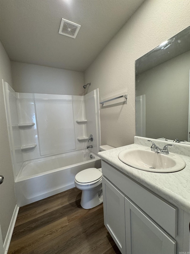 full bathroom featuring visible vents, toilet, bathtub / shower combination, wood finished floors, and vanity