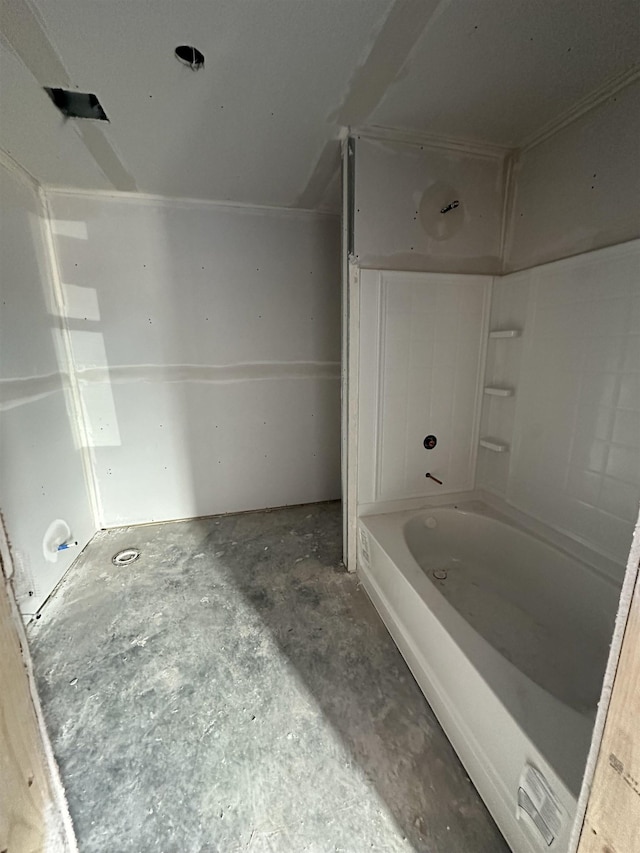 bathroom featuring concrete floors and a bathtub