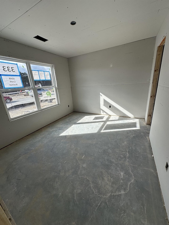 unfurnished room featuring concrete flooring