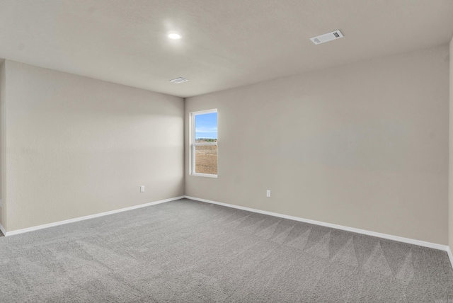 unfurnished room with carpet flooring, baseboards, and visible vents