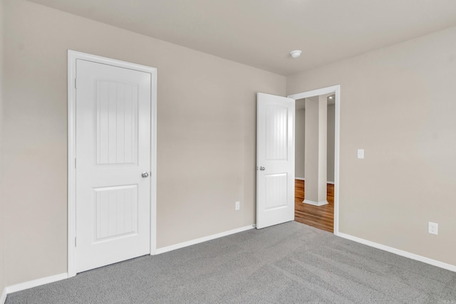 unfurnished bedroom with baseboards and carpet floors