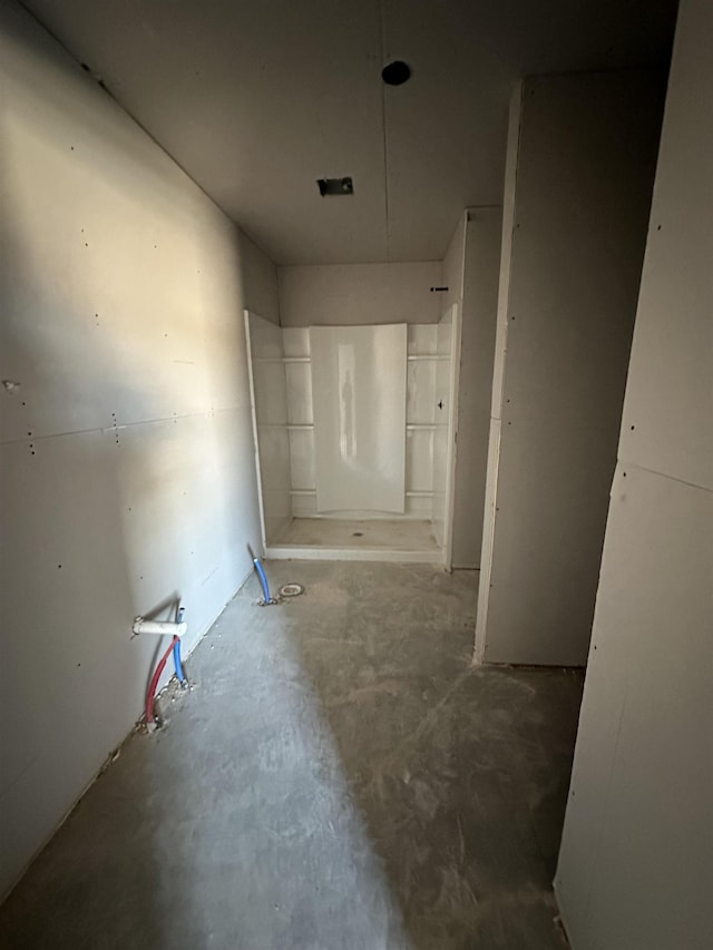 hallway with concrete flooring