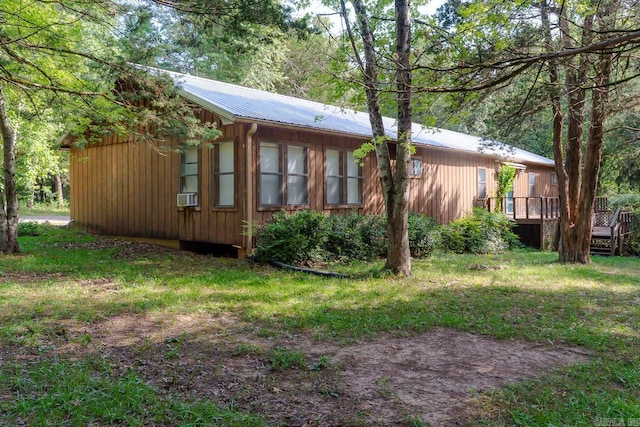 view of side of home featuring a deck and cooling unit