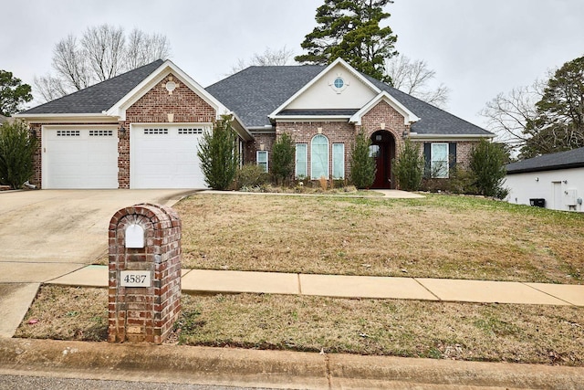 view of front of property featuring a front yard and a garage