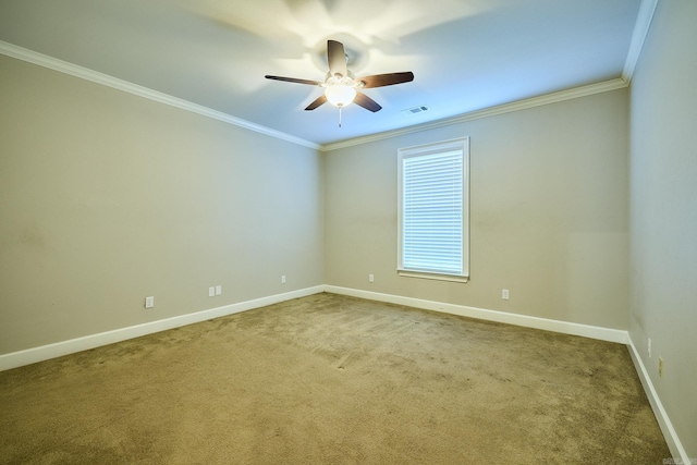 carpeted spare room featuring crown molding and ceiling fan