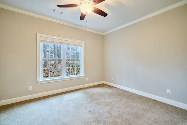 carpeted spare room featuring crown molding and ceiling fan